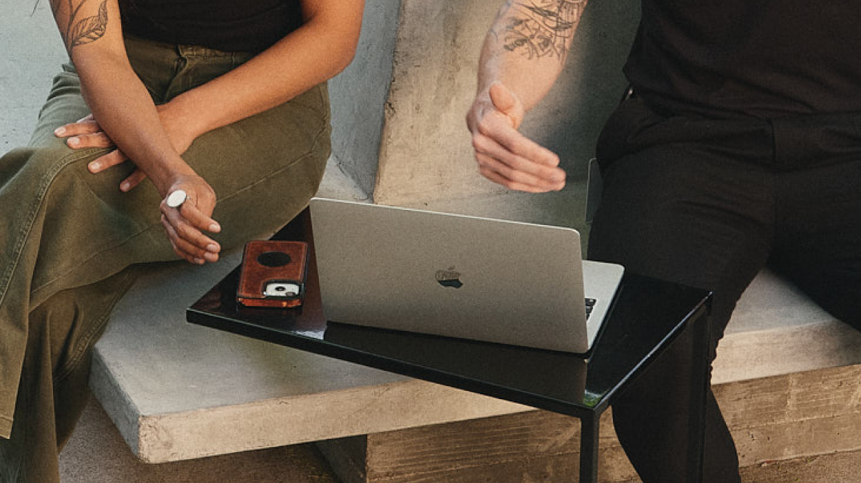 Two people looking at a laptop