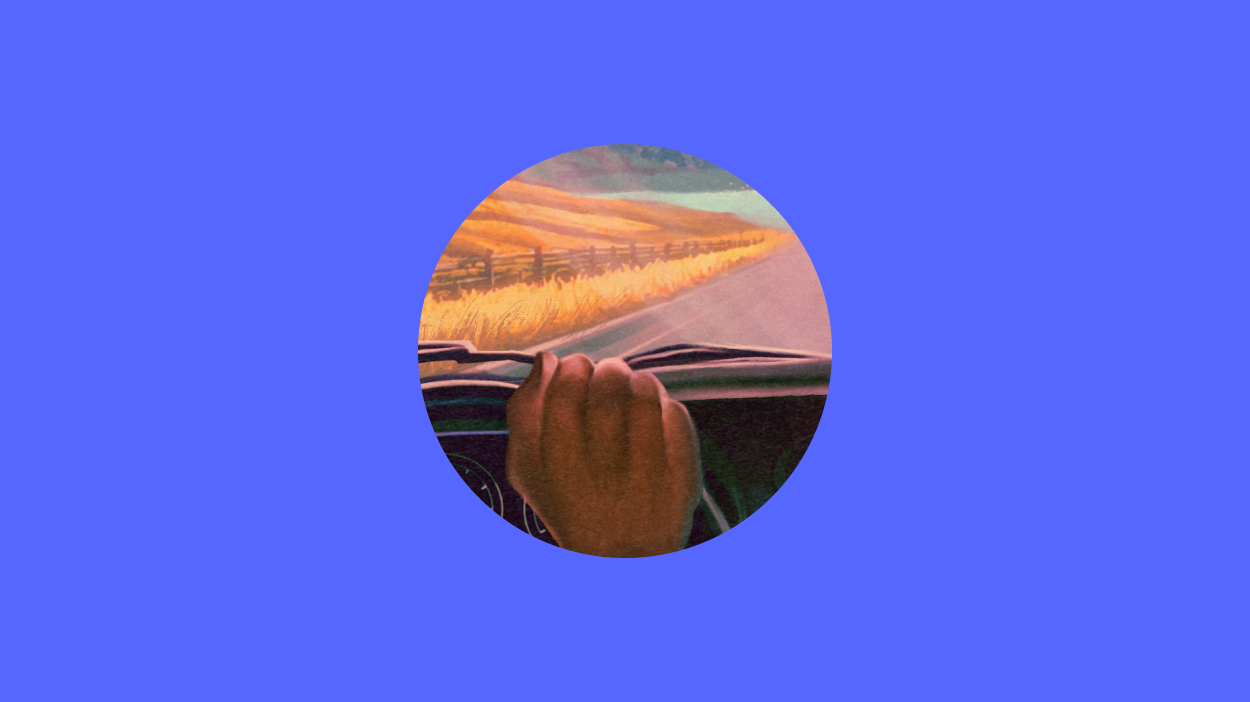 Hand on wheel on blue background