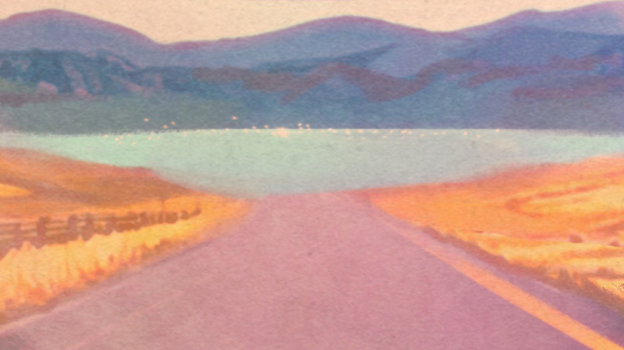 Open road with mountains in background