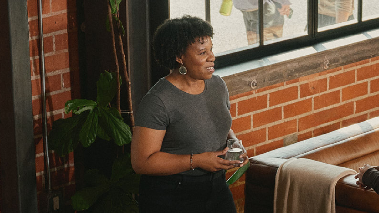 A person in an office setting talking with a colleague.