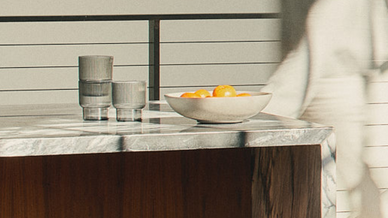 Photo of oranges in a bowl on a table at an office.