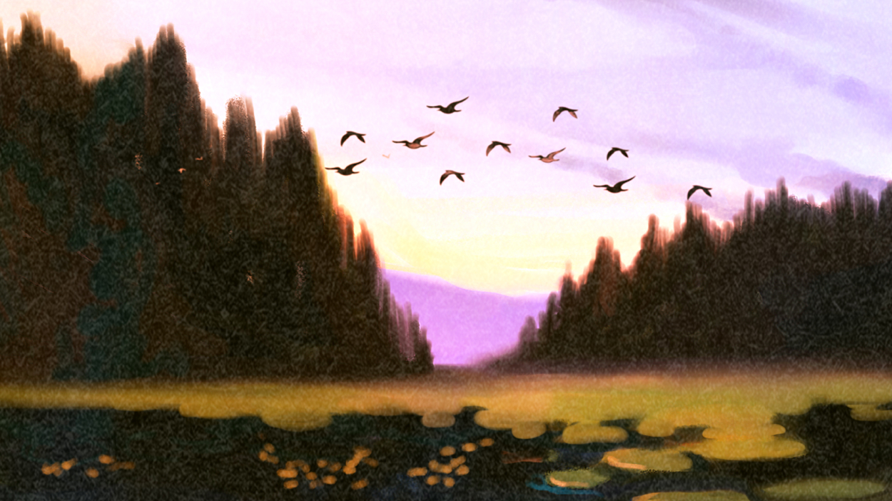 Birds flying over mountain lake