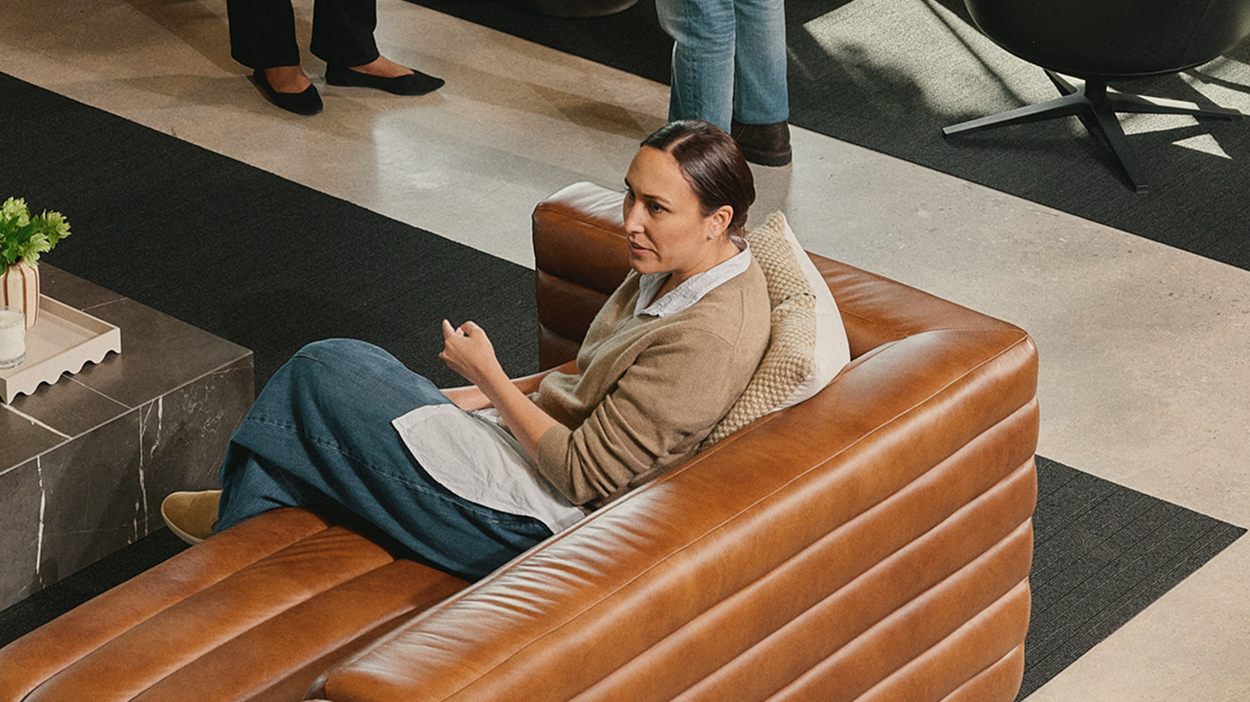 Advisor sitting on couch at a networking event